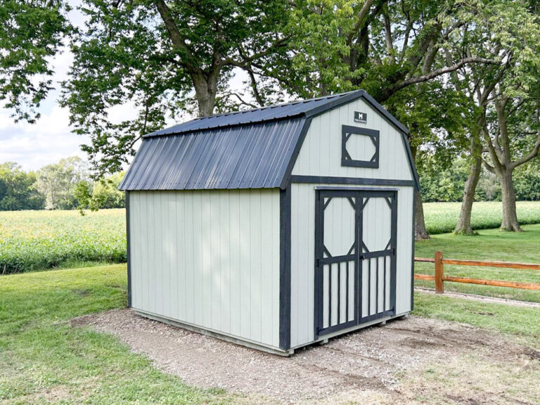 Small Lofted Barn with white siding and black trim and metal roofing