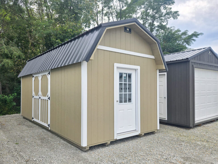 Lofted Barn tan siding with white trim and dark metal roof