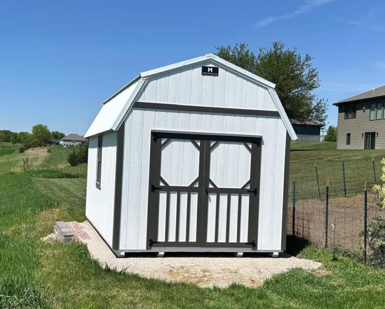 Lofted Barn white siding with dark trim and metal roof