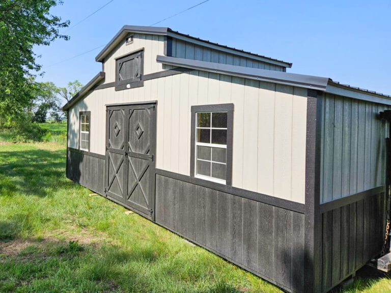 Country Barn with tan metal siding metal roof and dark trim