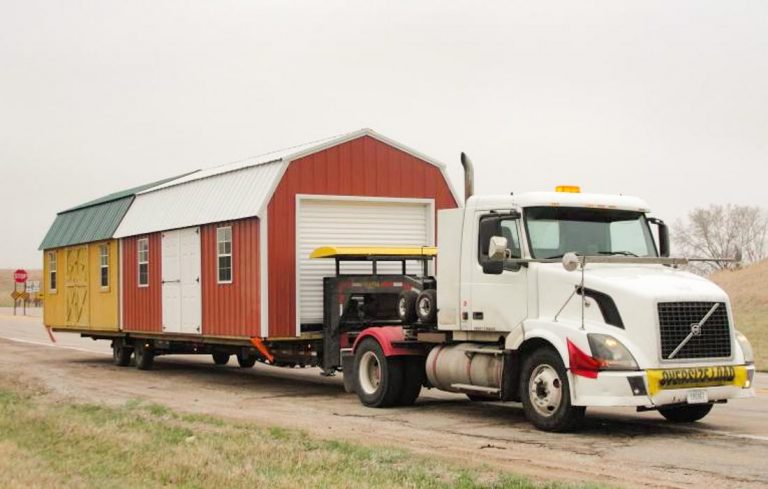 Mid-America Structure delivery truck with two sheds on the trailer