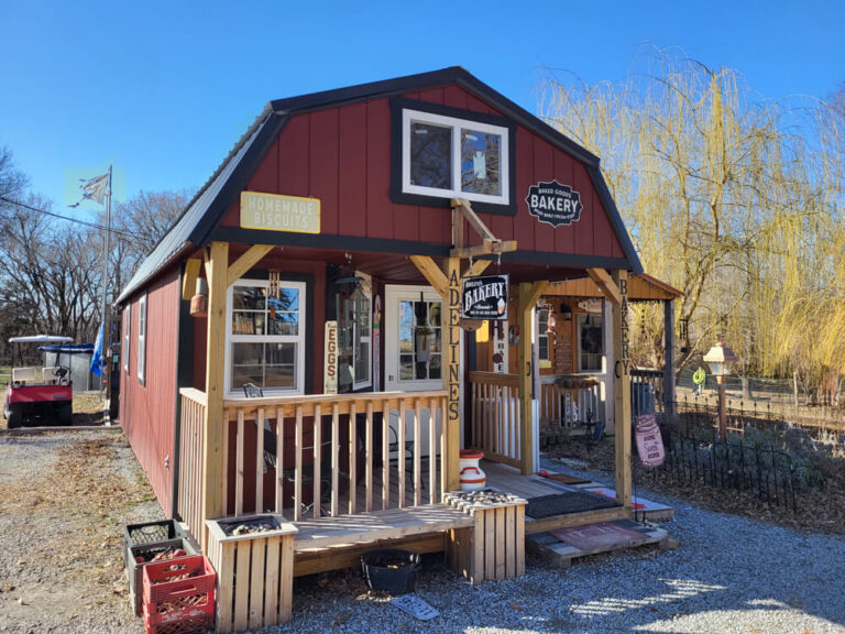 Deluxe Cabin country store with red siding and metal roof