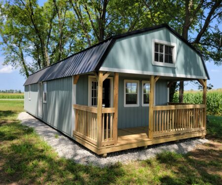 Pre-built cabin with loft in sage green and black.