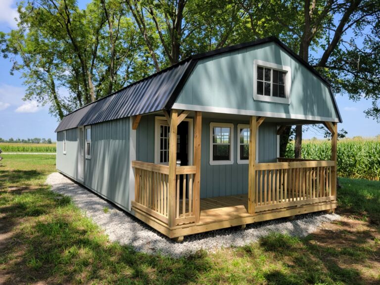 Pre-built cabin with loft in sage green and black.