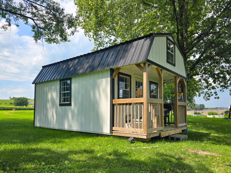 Lofted Cabin light siding with dark trim and metal roof