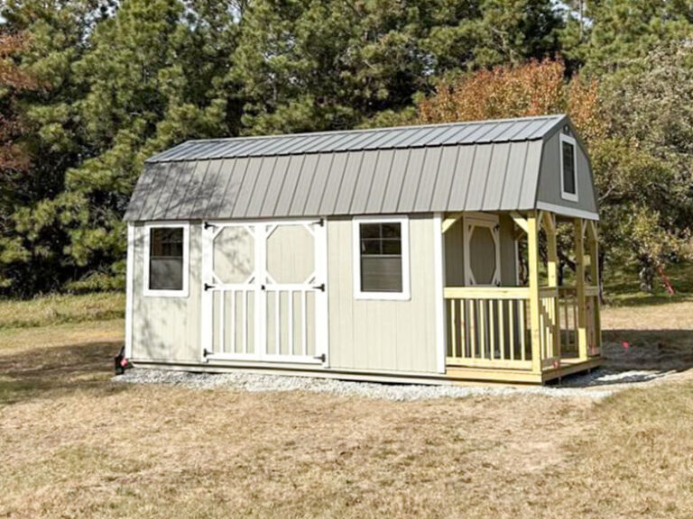 Lofted Cabin light siding with white trim and metal roof with porch and wooden railing