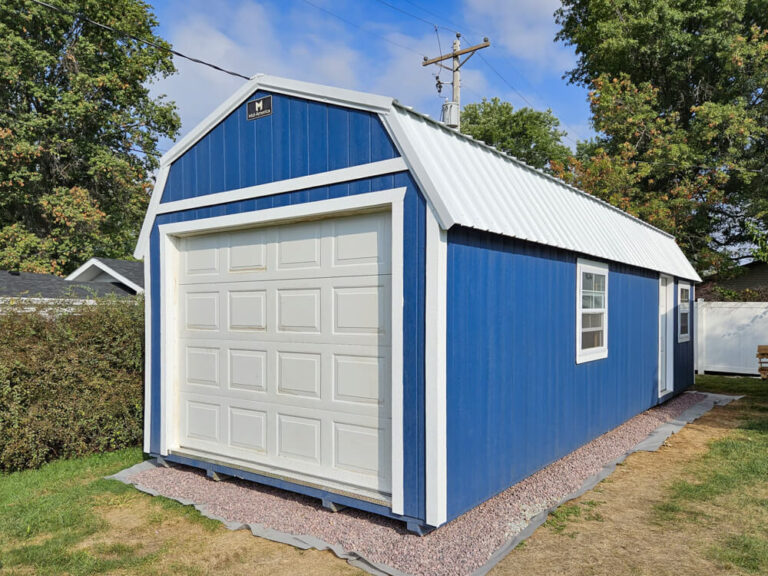 Lofted Garage blue metal siding with white trim and metal roof
