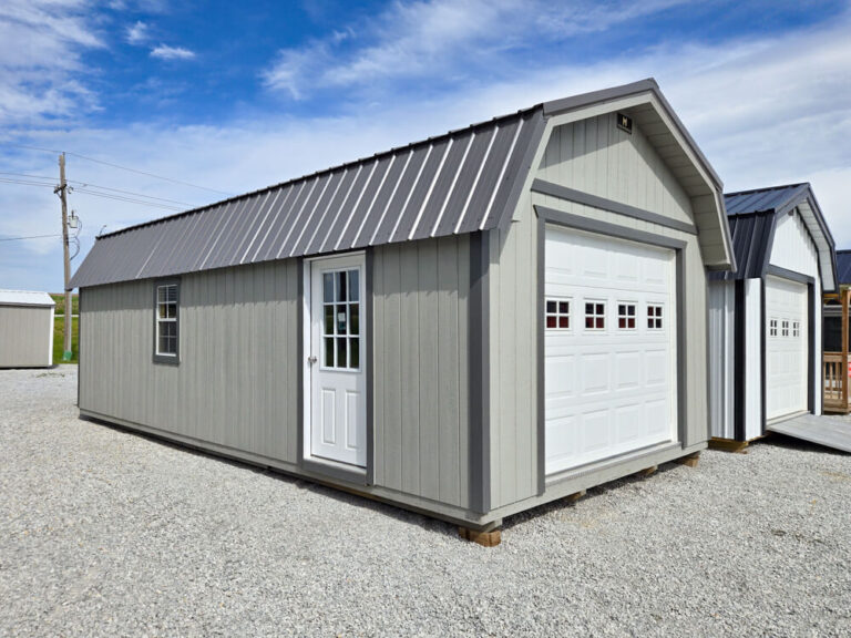 Lofted Garage gray siding with dark trim and metal roof