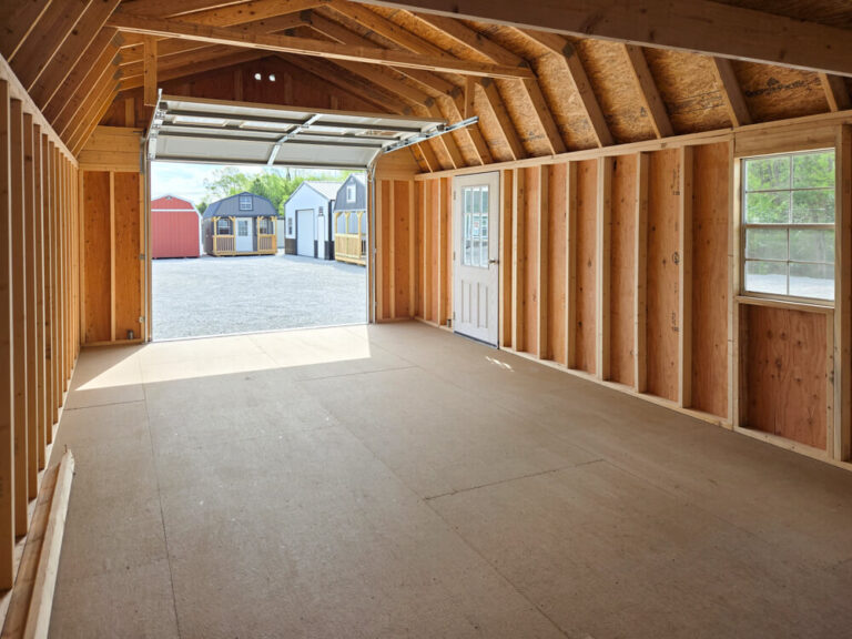 Lofted Garage interior view facing open overhead door