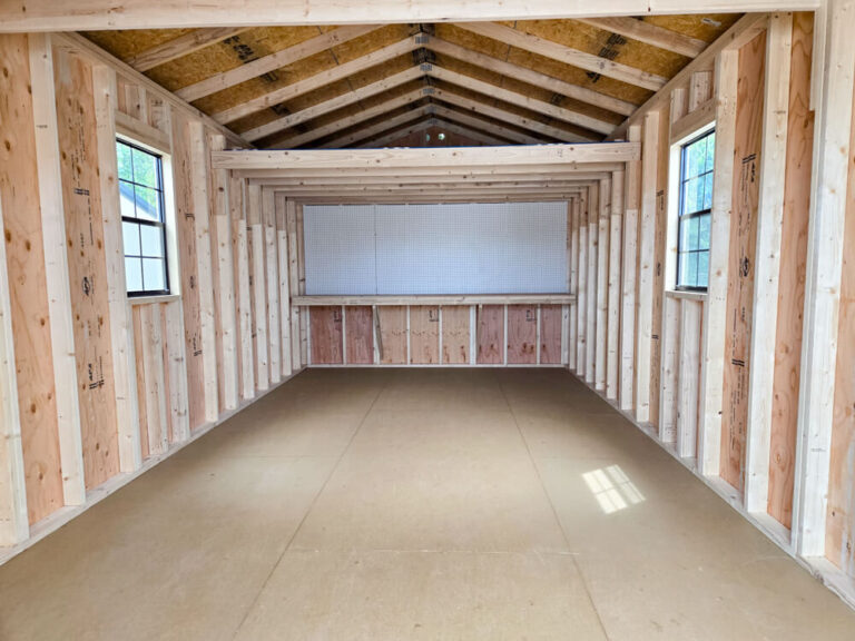 Lofted Utility Shed inside view looking back towards workbench and pegboard