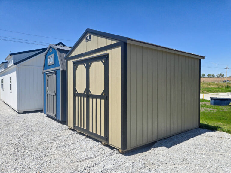 Lofted Utility Shed small tan siding with dark trim and metal roof