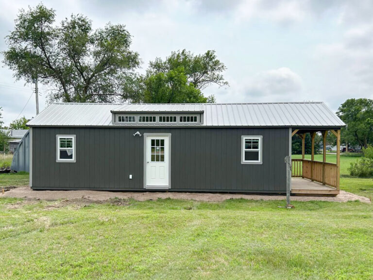 Swiss Cabin dark siding trim and metal roof wooden porch railing