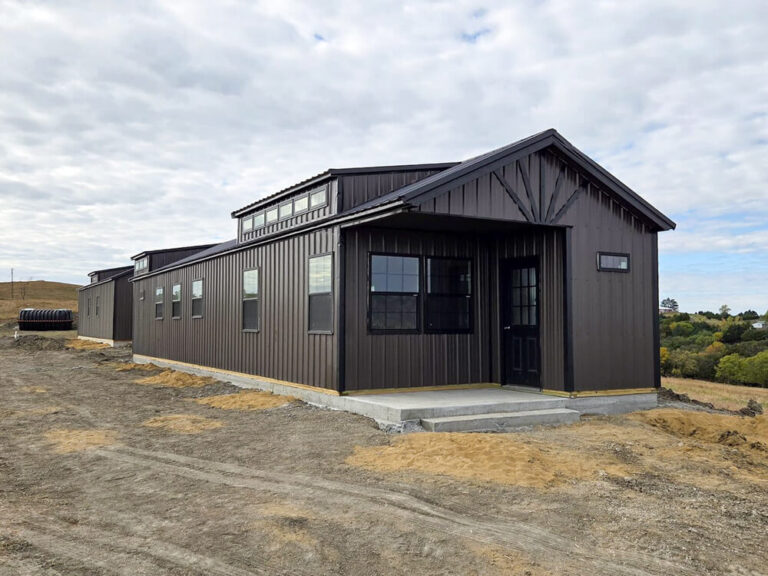 Swiss Cabin large with dark siding trim and metal roof
