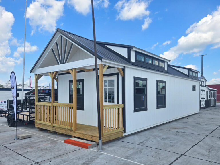 Swiss Cabin white siding black trim and metal roof two transom windows in roof