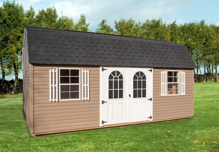 Lofted Garden Shed by Mid-America Structures on a green lawn with tree line in background