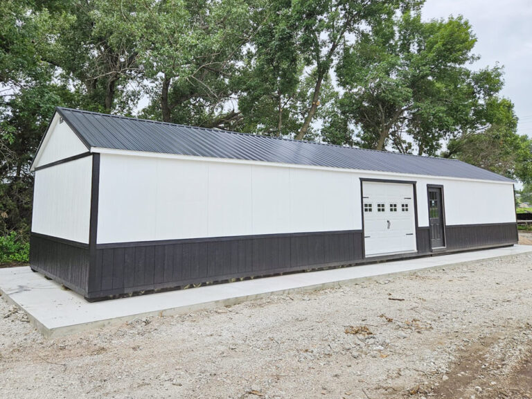 Legacy Garage large garage with white metal siding black metal roof and trim