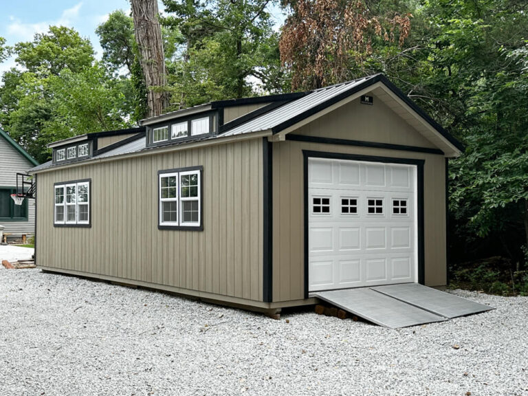 Legacy Garage single car overhead door gray siding with dark trim and metal roof two transom windows on roof