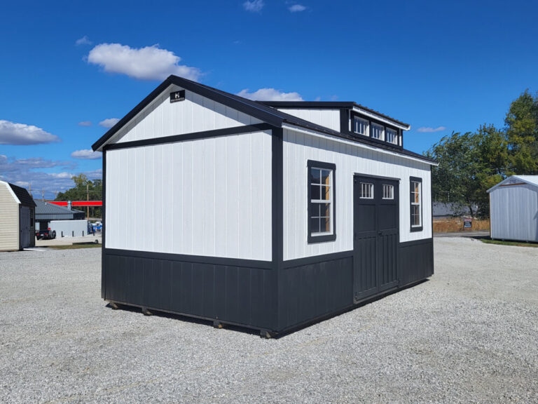 Villa white siding black trim and metal roof transom window in roof