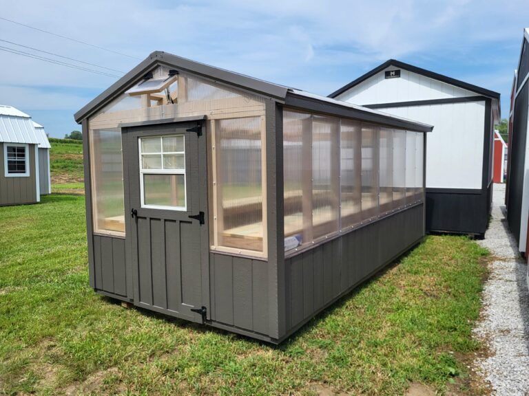 a picture of the outside of a dark grey greenhouse with plastic sides made by MidAmerica Structures