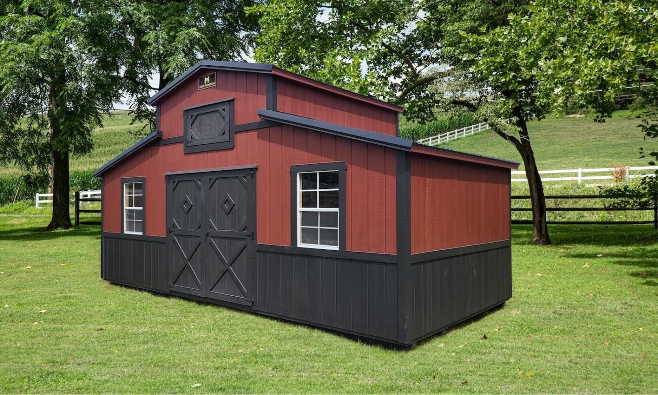 wooden mini barn with redish brown siding and dark brown trim