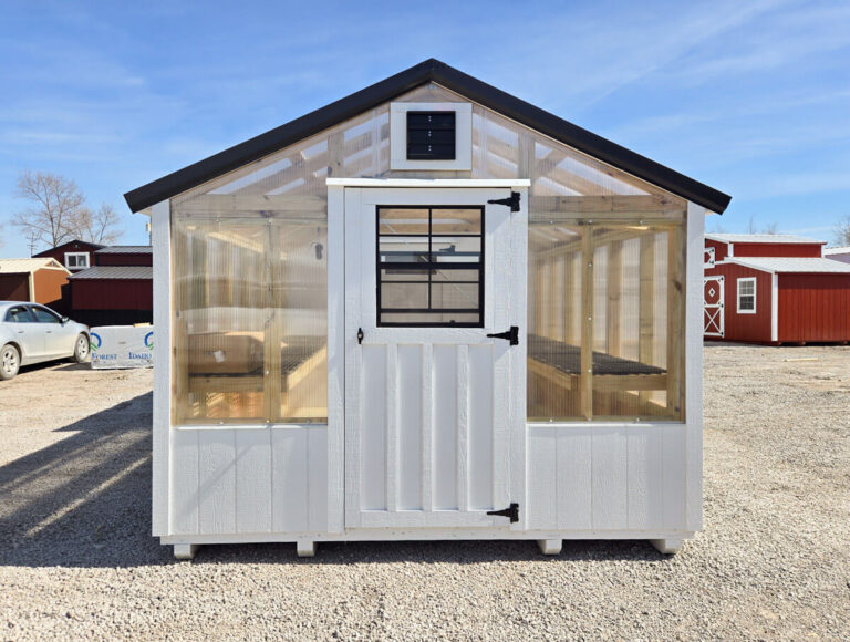 front of greenhouse combo with white siding and black metal roof by MidAmerica Structures