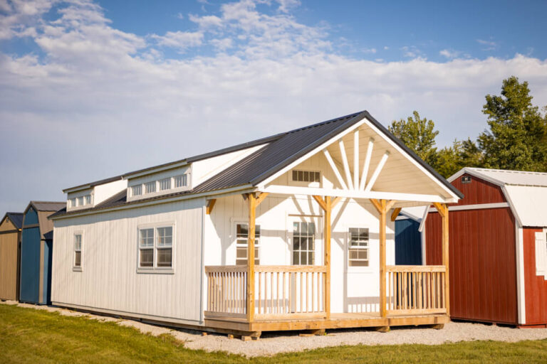 Swiss Cabin white siding and trim with dark metal roof with two transom windows porch with wood railing Shed Gallery