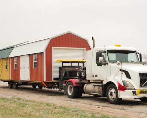Mid-America Structure delivery truck with two sheds on the trailer